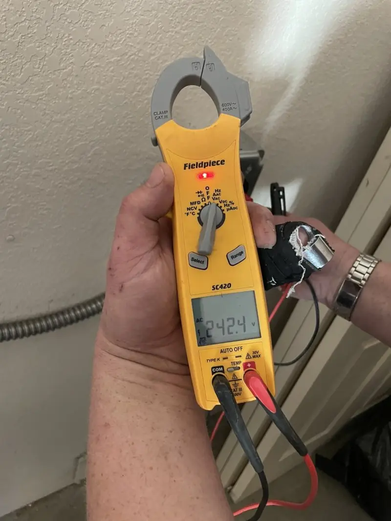 Voltage testing with clamp meter during Electrical Installation Services in Metzger